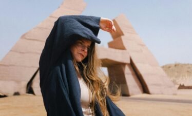 Woman stands at Ras Mohamed Nature Reserve in Egypt, posing stylishly.