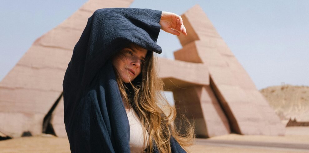 Woman stands at Ras Mohamed Nature Reserve in Egypt, posing stylishly.