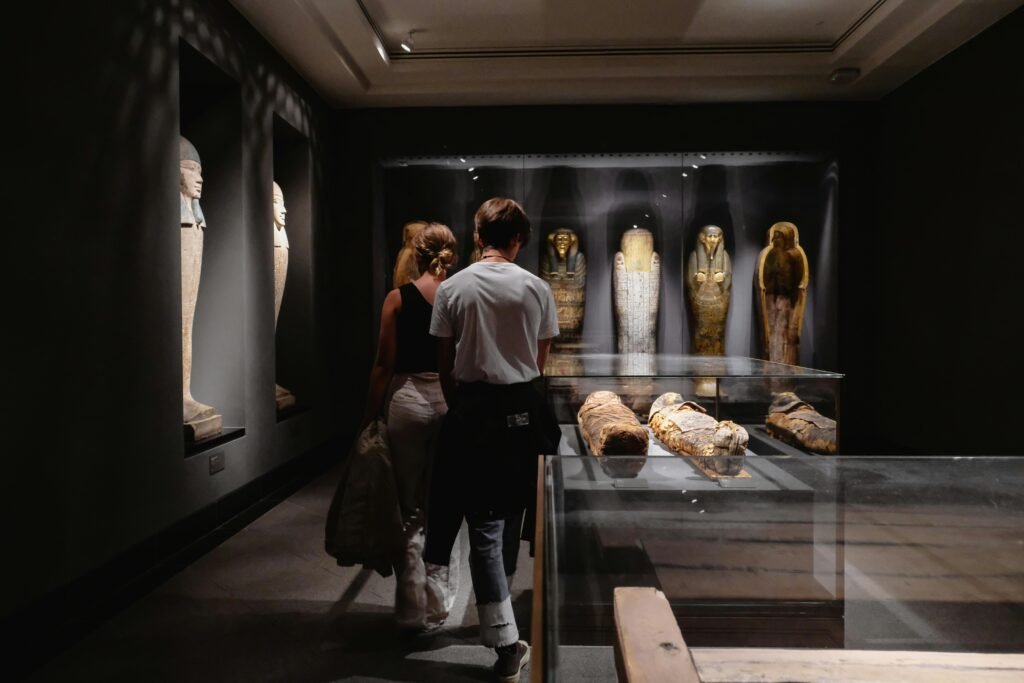 Visitors explore Egyptian artifacts at a museum in Copenhagen.