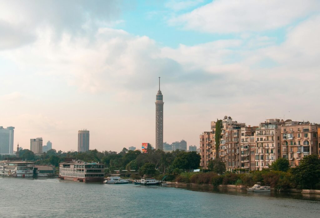 Beautiful view of Cairo skyline featuring the iconic Cairo Tower and downtown architecture along the Nile River.